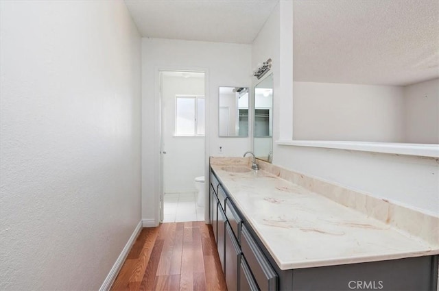 23405 Ramona Ave, Apple Valley, CA 92307 - bathroom featuring wood finished floors and double vanity