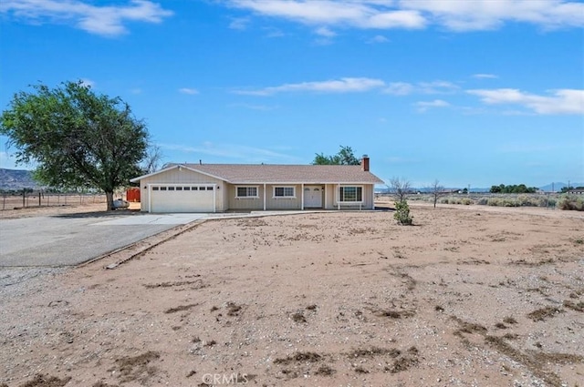 23405 Ramona Ave, Apple Valley, CA 92307 - ranch-style home featuring concrete driveway, a garage, and a chimney