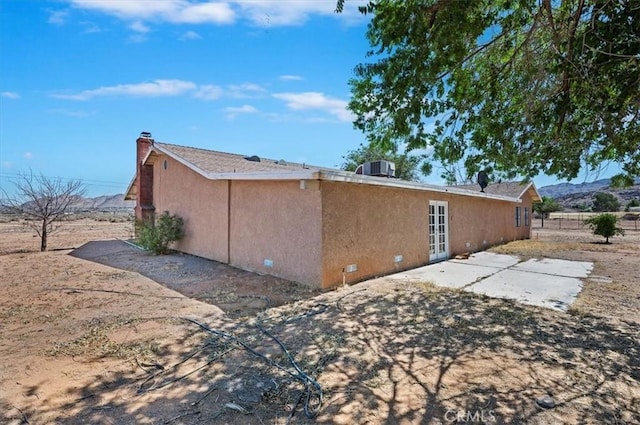 23405 Ramona Ave, Apple Valley, CA 92307 - view of property exterior with a patio, french doors, and stucco siding
