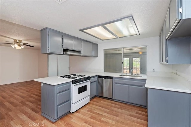 23405 Ramona Ave, Apple Valley, CA 92307 - kitchen featuring gas range gas stove, stainless steel dishwasher, gray cabinetry, a textured ceiling, and ceiling fan