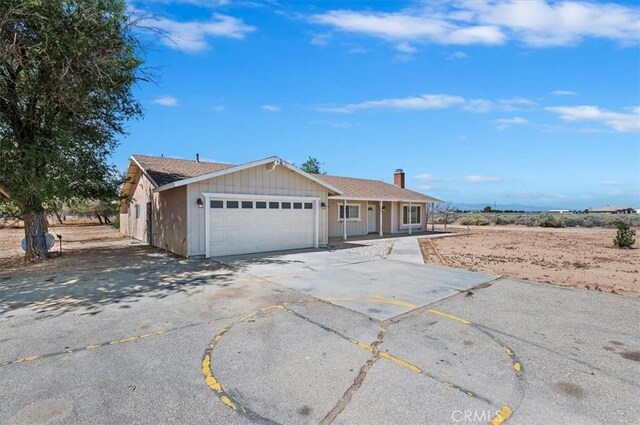 23405 Ramona Ave, Apple Valley, CA 92307 - single story home with a garage, driveway, and covered porch
