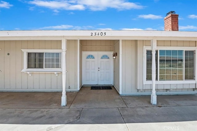 23405 Ramona Ave, Apple Valley, CA 92307 - property entrance with a chimney
