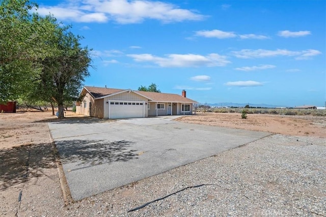 23405 Ramona Ave, Apple Valley, CA 92307 - ranch-style house with concrete driveway, a garage, and a chimney