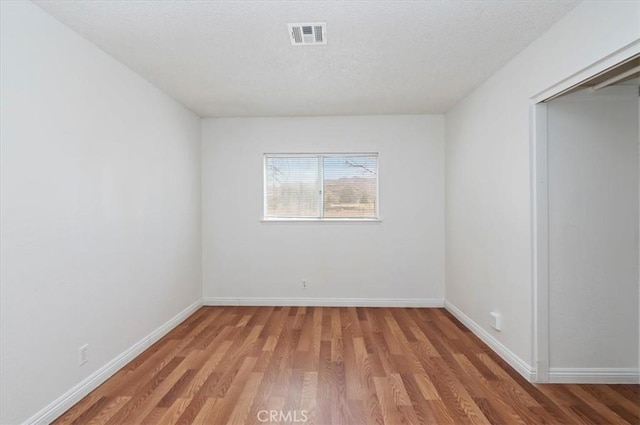 23405 Ramona Ave, Apple Valley, CA 92307 - spare room featuring light wood-type flooring and a textured ceiling