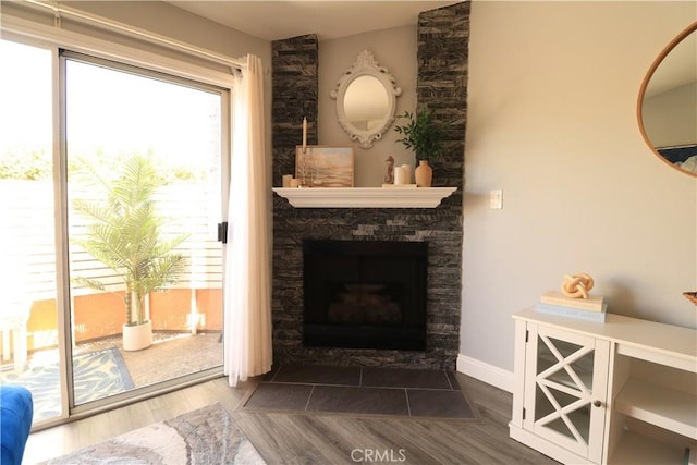 14005 Arthur Ave Unit 21, Paramount, CA 90723 - living area with a stone fireplace and wood finished floors