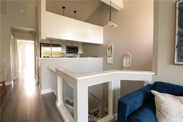 14005 Arthur Ave Unit 21, Paramount, CA 90723 - corridor featuring high vaulted ceiling, an upstairs landing, and dark wood finished floors