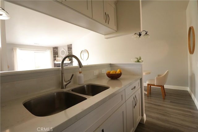 14005 Arthur Ave Unit 21, Paramount, CA 90723 - kitchen with dark wood-type flooring and white cabinets