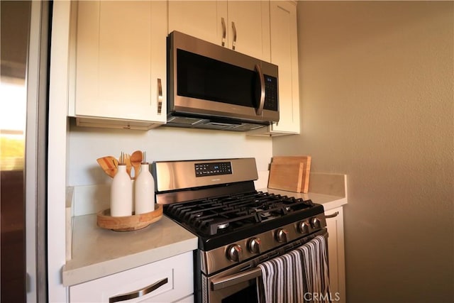 14005 Arthur Ave Unit 21, Paramount, CA 90723 - kitchen featuring stainless steel appliances, light countertops, and white cabinets