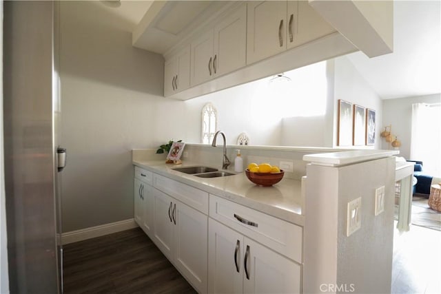 14005 Arthur Ave Unit 21, Paramount, CA 90723 - kitchen featuring light countertops, white cabinets, and dark wood finished floors