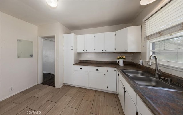 35354 Ave A, Yucaipa, CA 92399 - kitchen with dark countertops, white cabinetry, and wood finish floors