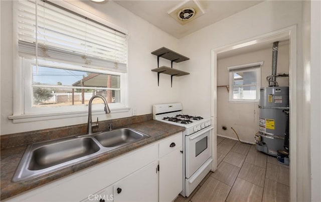 35354 Ave A, Yucaipa, CA 92399 - kitchen featuring white gas range oven, strapped water heater, dark countertops, white cabinets, and open shelves