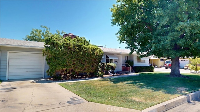125 Hilton St, Madera, CA 93637 - view of front of home with a front yard, concrete driveway, and a garage