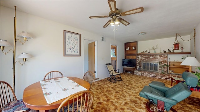 125 Hilton St, Madera, CA 93637 - dining area featuring ceiling fan, a fireplace, and carpet flooring