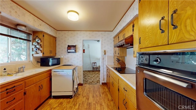 125 Hilton St, Madera, CA 93637 - kitchen with black appliances, wallpapered walls, light wood-style floors, tile countertops, and under cabinet range hood