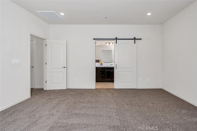 860 Fritz Dr, Los Banos, CA 93635 - unfurnished bedroom with light colored carpet, recessed lighting, and connected bathroom