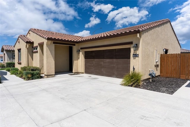 860 Fritz Dr, Los Banos, CA 93635 - mediterranean / spanish house featuring an attached garage, stucco siding, a tiled roof, and driveway