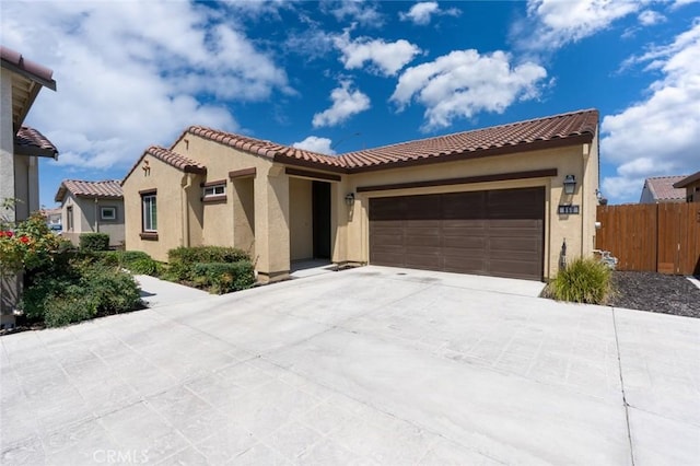 860 Fritz Dr, Los Banos, CA 93635 - mediterranean / spanish-style house featuring a garage, stucco siding, driveway, and a tile roof
