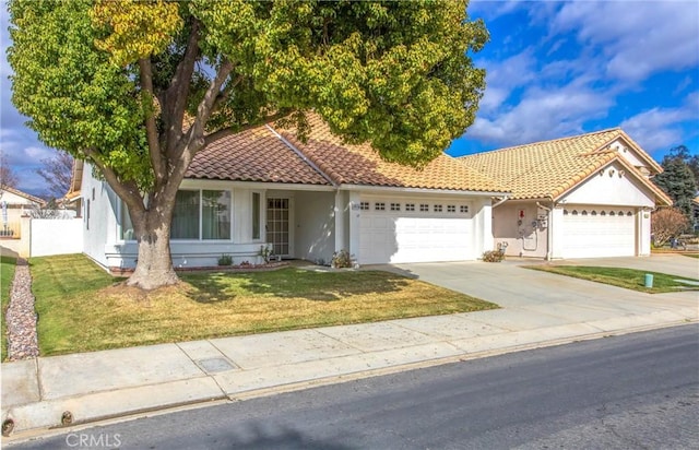 6287 Tuckaway Ave, Banning, CA 92220 - view of front of home featuring stucco siding, a garage, a tile roof, and driveway
