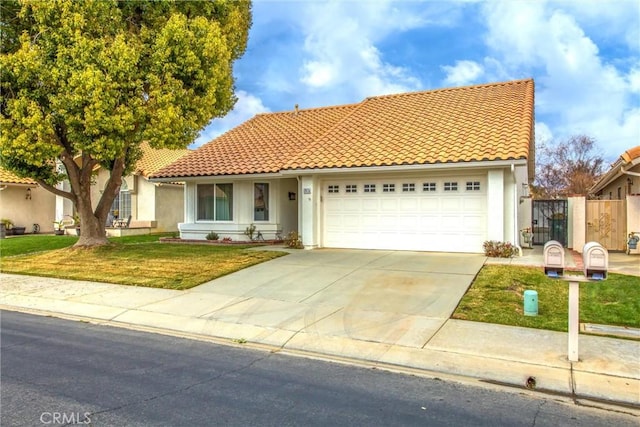 6287 Tuckaway Ave, Banning, CA 92220 - mediterranean / spanish-style house featuring stucco siding, a tiled roof, concrete driveway, and an attached garage