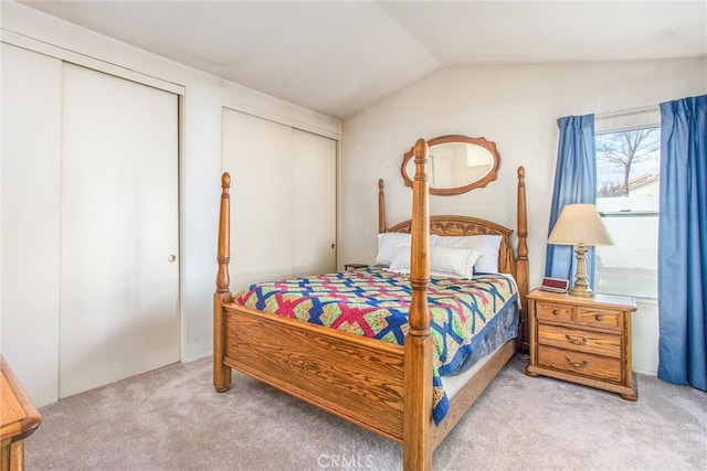 6287 Tuckaway Ave, Banning, CA 92220 - bedroom featuring multiple closets, light carpet, and lofted ceiling