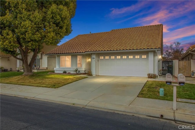 6287 Tuckaway Ave, Banning, CA 92220 - mediterranean / spanish-style house with a tile roof, concrete driveway, stucco siding, and a garage
