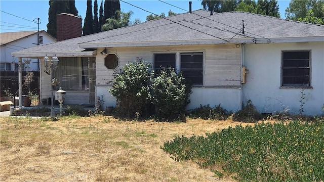 7044 Pellet St, Downey, CA 90241 - view of front facade featuring roof with shingles, a front lawn, and a chimney