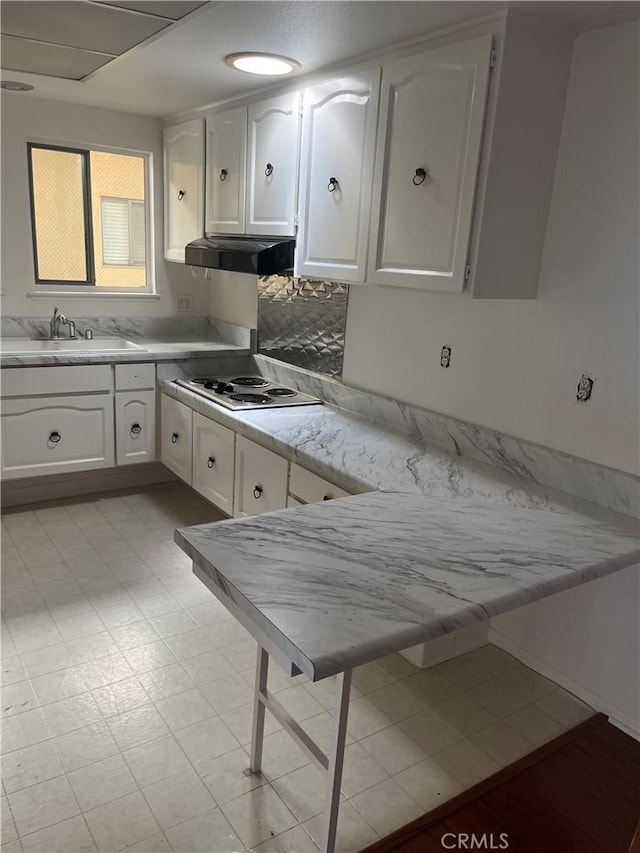 834UnitP Ronda Mendoza, Laguna Woods, CA 92637 - kitchen featuring stainless steel electric stovetop, white cabinets, and ventilation hood