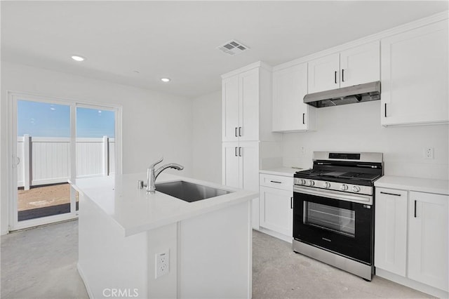 10132 Kemper Ave, Adelanto, CA 92301 - kitchen with stainless steel range with gas stovetop, under cabinet range hood, finished concrete floors, white cabinets, and recessed lighting