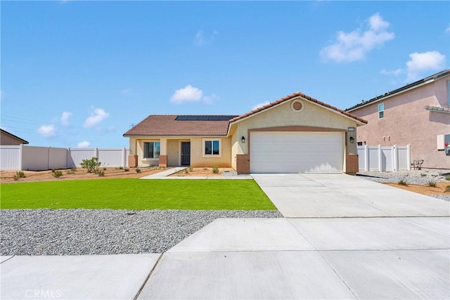 10132 Kemper Ave, Adelanto, CA 92301 - view of front of home with a tile roof, stucco siding, solar panels, an attached garage, and driveway