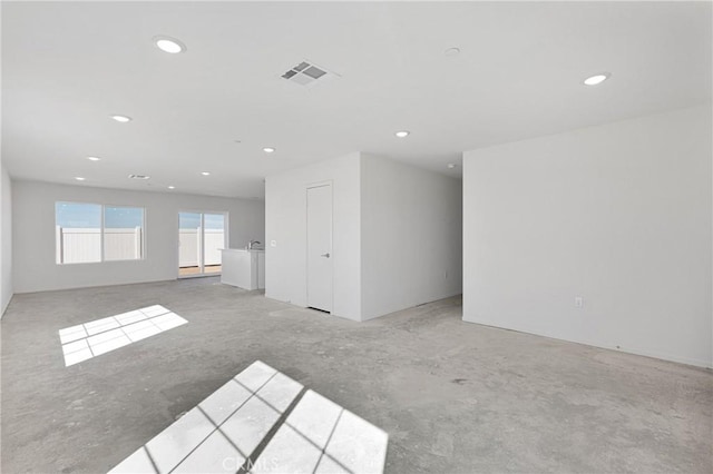 10132 Kemper Ave, Adelanto, CA 92301 - empty room featuring recessed lighting and unfinished concrete floors