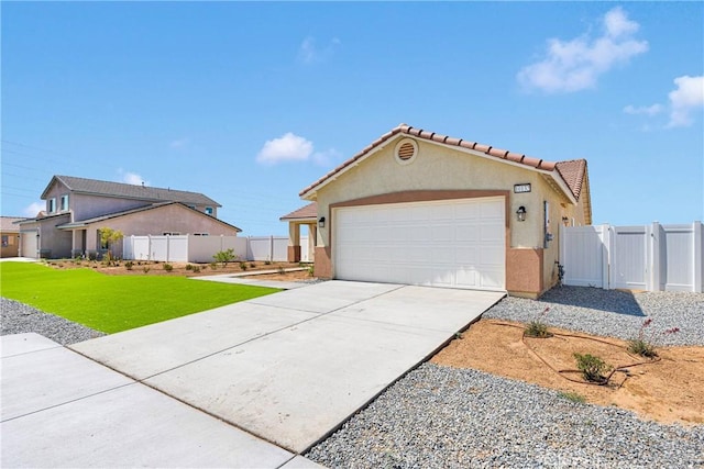 10132 Kemper Ave, Adelanto, CA 92301 - view of front of home featuring driveway, stucco siding, an attached garage, and a tiled roof