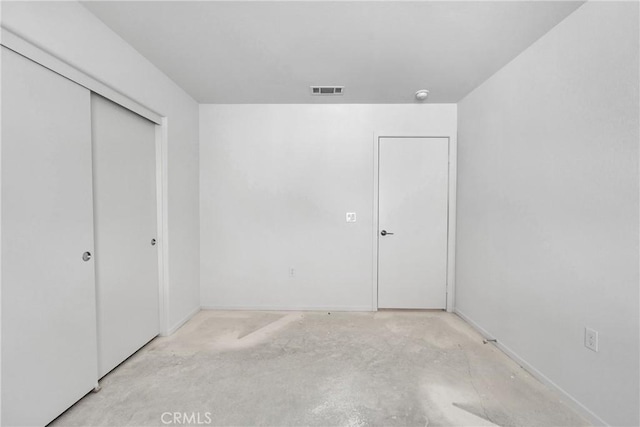 10132 Kemper Ave, Adelanto, CA 92301 - unfurnished bedroom featuring concrete floors and a closet