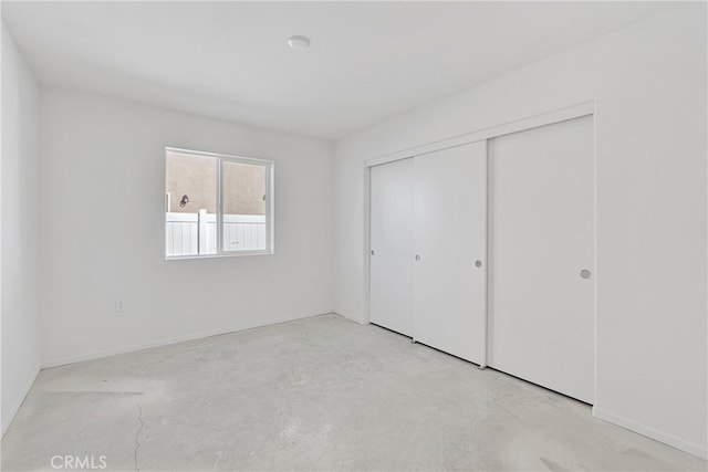 10132 Kemper Ave, Adelanto, CA 92301 - unfurnished bedroom with concrete floors and a closet