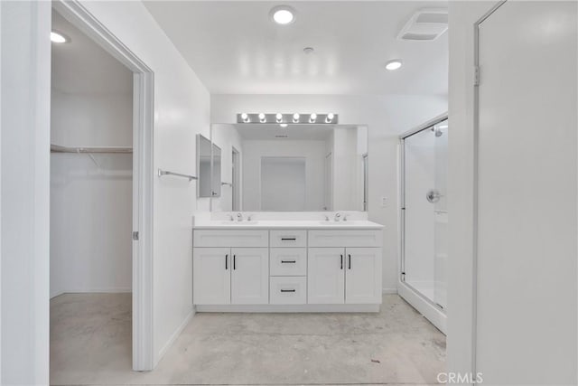 10132 Kemper Ave, Adelanto, CA 92301 - full bath with a shower stall, double vanity, concrete floors, a spacious closet, and recessed lighting