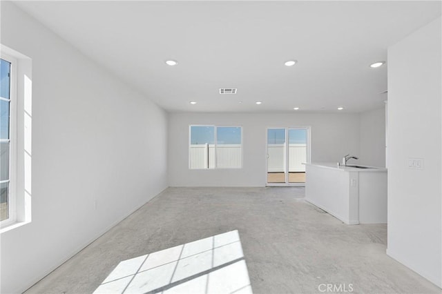 10132 Kemper Ave, Adelanto, CA 92301 - empty room featuring recessed lighting and light colored carpet