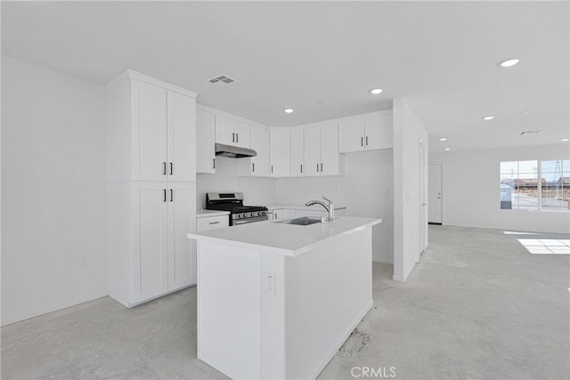 10132 Kemper Ave, Adelanto, CA 92301 - kitchen featuring stainless steel gas stove, under cabinet range hood, white cabinets, concrete floors, and recessed lighting