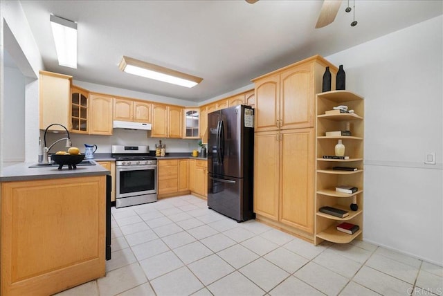 8149 Calico St, San Diego, CA 92126 - kitchen with stainless steel gas range oven, freestanding refrigerator, light brown cabinets, and under cabinet range hood