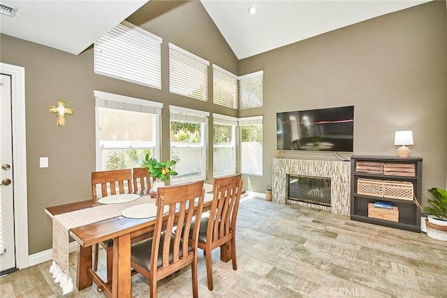 19 Las Cruces, Irvine, CA 92614 - dining space featuring high vaulted ceiling and a glass covered fireplace