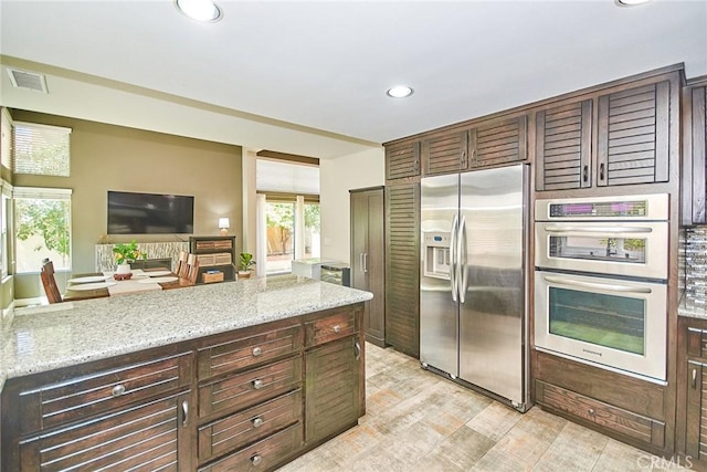 19 Las Cruces, Irvine, CA 92614 - kitchen featuring stainless steel appliances, recessed lighting, light stone counters, and light wood-style floors