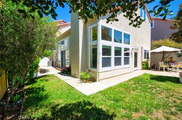19 Las Cruces, Irvine, CA 92614 - back of house with stucco siding, a patio area, and a yard