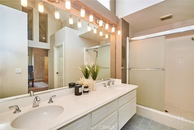 19 Las Cruces, Irvine, CA 92614 - ensuite bathroom with tile patterned flooring, tiled shower, and double vanity