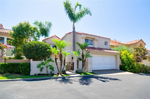 19 Las Cruces, Irvine, CA 92614 - mediterranean / spanish home with stucco siding, a tiled roof, concrete driveway, and an attached garage