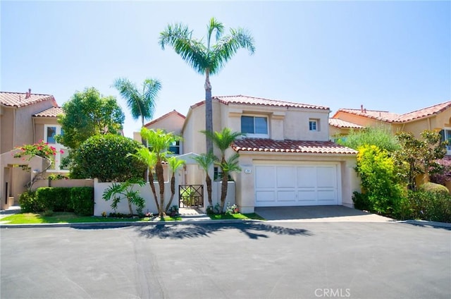 19 Las Cruces, Irvine, CA 92614 - mediterranean / spanish house featuring stucco siding, a tile roof, driveway, and an attached garage