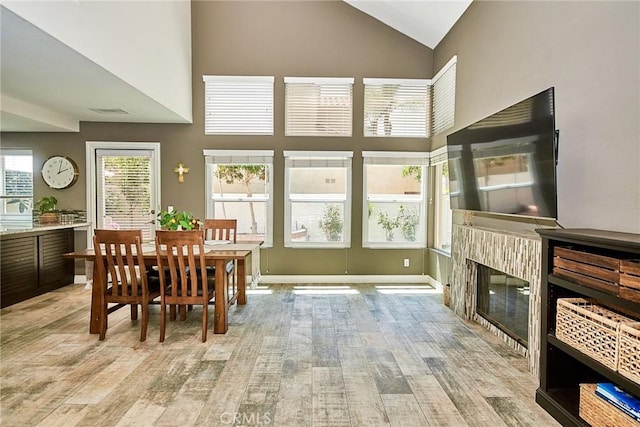 19 Las Cruces, Irvine, CA 92614 - dining room featuring light wood finished floors, high vaulted ceiling, and a glass covered fireplace