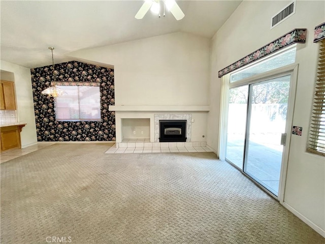 224 Stonewood Dr, Los Banos, CA 93635 - unfurnished living room with lofted ceiling, a tiled fireplace, carpet, and ceiling fan