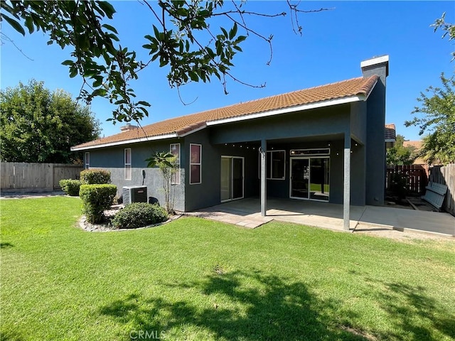 224 Stonewood Dr, Los Banos, CA 93635 - back of house featuring stucco siding, a tiled roof, a patio area, and a chimney