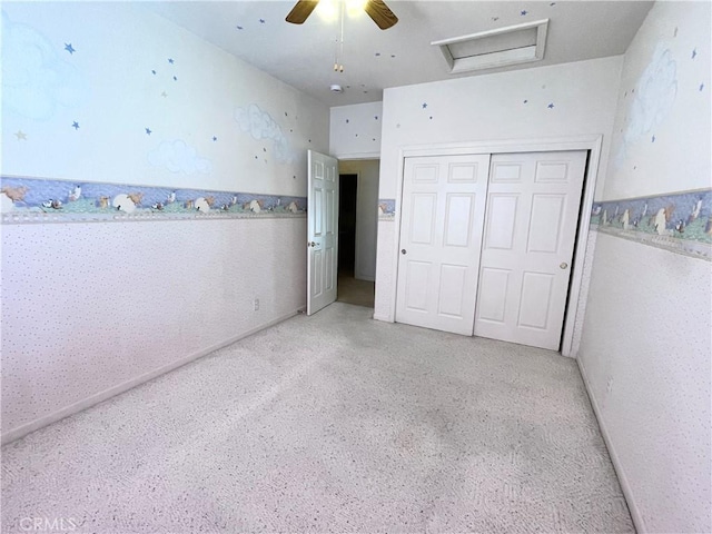 224 Stonewood Dr, Los Banos, CA 93635 - unfurnished bedroom with attic access, a closet, a ceiling fan, and dark speckled floor
