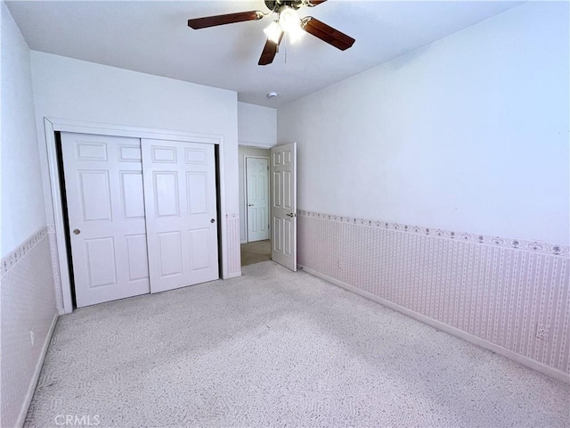 224 Stonewood Dr, Los Banos, CA 93635 - unfurnished bedroom featuring a closet, wainscoting, carpet flooring, and a ceiling fan