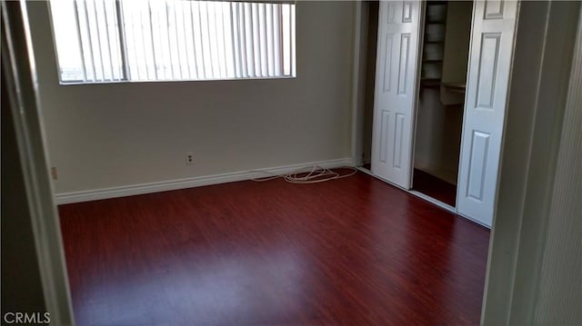 545 Chestnut Ave Unit 207, Long Beach, CA 90802 - unfurnished bedroom featuring multiple windows, wood finished floors, and a closet
