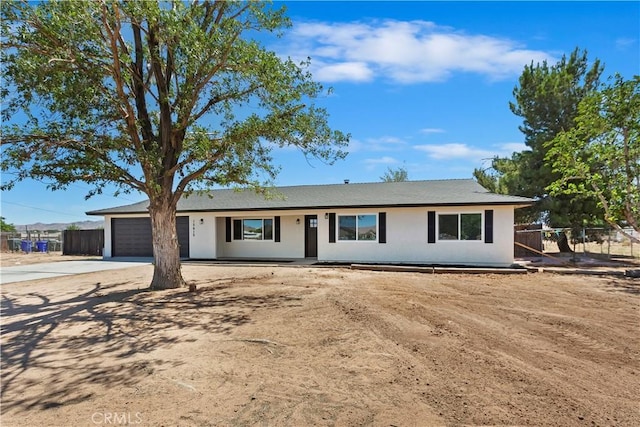 15615 Erie Rd, Apple Valley, CA 92307 - ranch-style house with concrete driveway and a garage